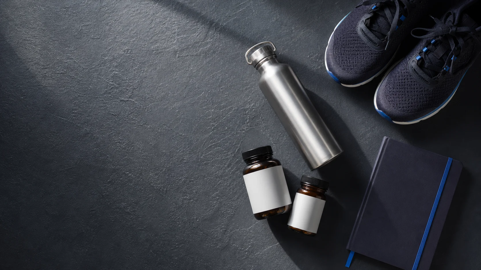 Weekly lifestyle protocol flat-lay with supplements, water bottle, and journal
