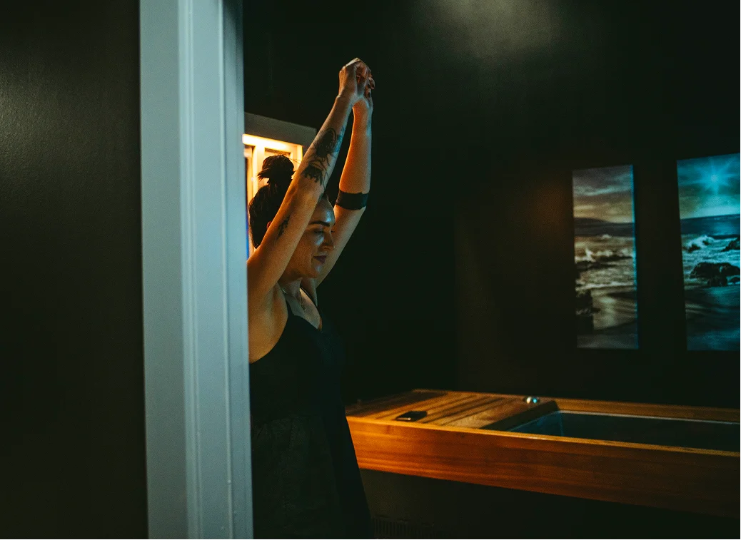 Contrast therapy suite with cold plunge tub and warm-wood paneling at InnerWorks