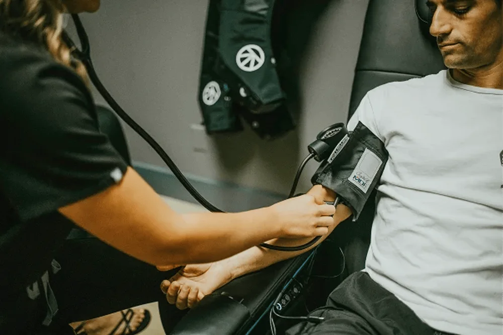 Provider strapping an assessment cuff during a fitness evaluation at InnerWorks