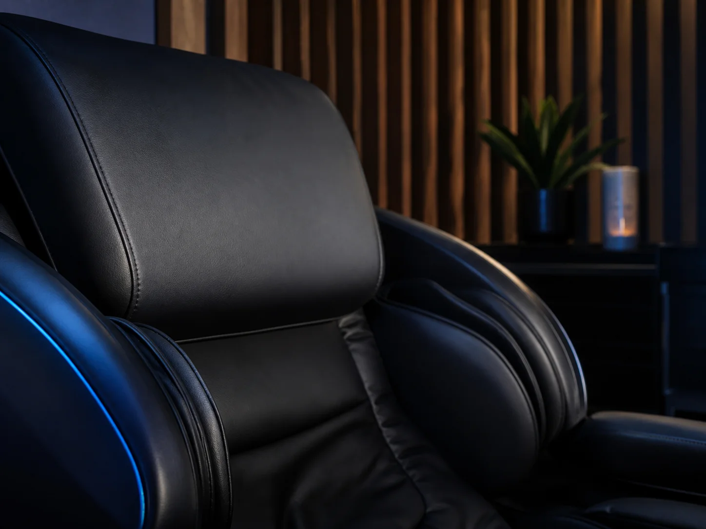Stitched leather headrest of a full-body massage chair in the relaxation lounge