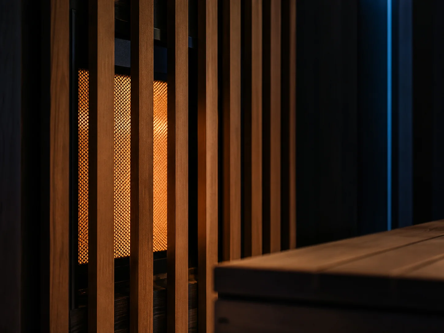 Infrared heating panel glowing behind cedar slats inside the sauna cabin