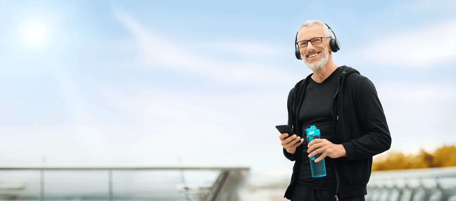 A fit, confident elderly man leaves the med spa after treatment