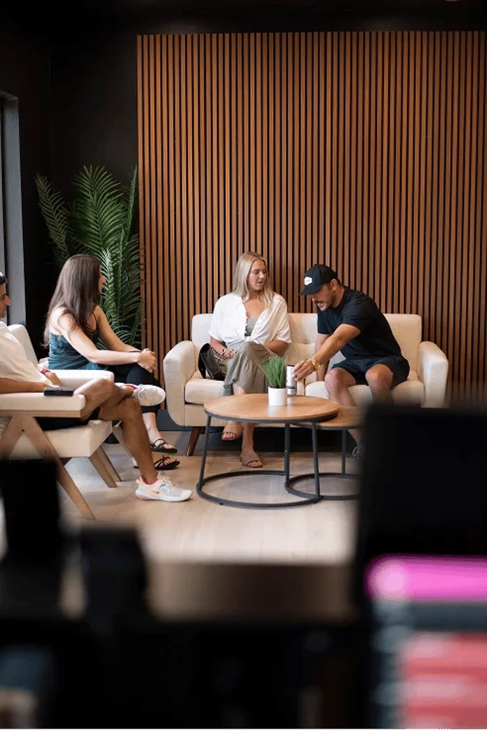 Four people sitting on couches in a clinic lobby