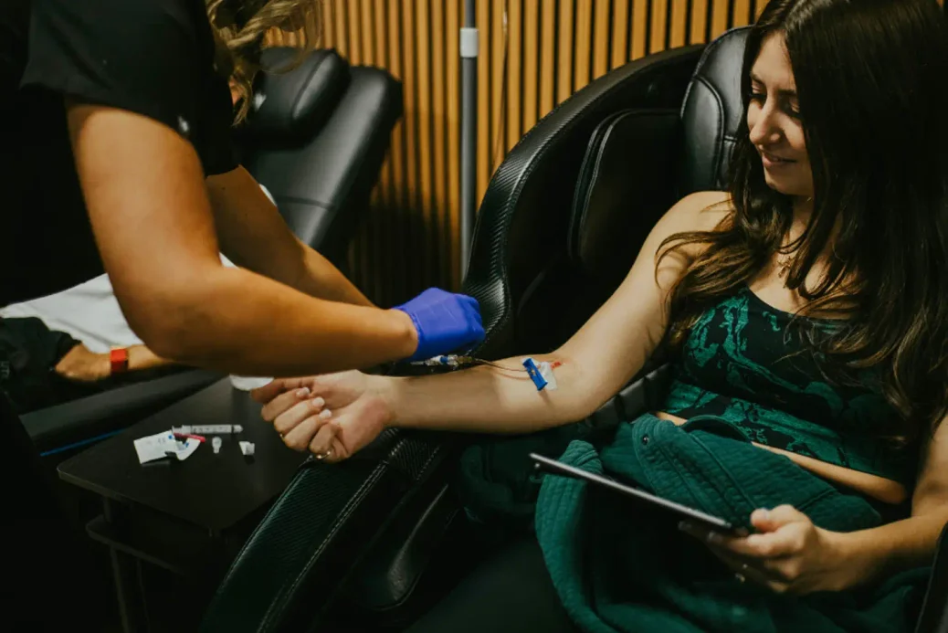InnerWorks provider starting an IV for a smiling patient in the St. Augustine clinic
